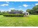 A lush backyard featuring a screened-in pool enclosure offering relaxation and privacy, set against mature trees at 8940 Sw 8Th St, Ocala, FL 34481