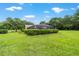The backyard has a screened-in pool area surrounded by lush green landscaping, adding privacy and beauty at 8940 Sw 8Th St, Ocala, FL 34481