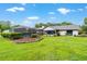Expansive backyard showcasing a screened-in pool and meticulously landscaped garden beds adding to the home's charm at 8940 Sw 8Th St, Ocala, FL 34481