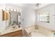 Bathroom with a vanity, a soaking tub, and a large window at 8940 Sw 8Th St, Ocala, FL 34481