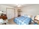 Bedroom with a closet and blue and white patterned bedspread at 8940 Sw 8Th St, Ocala, FL 34481