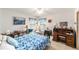 Bedroom with a bed, two windows, and a desk with chair at 8940 Sw 8Th St, Ocala, FL 34481