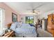 Comfortable bedroom featuring a ceiling fan, a desk, and sliding glass doors to the backyard at 8940 Sw 8Th St, Ocala, FL 34481