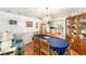 Dining room with wainscoting beneath chair rail, view into the kitchen, and a blue tablecloth at 8940 Sw 8Th St, Ocala, FL 34481