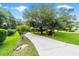 Long driveway leading to a beautiful home surrounded by lush greenery at 8940 Sw 8Th St, Ocala, FL 34481