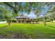 Charming home featuring a well-manicured lawn and mature landscaping at 8940 Sw 8Th St, Ocala, FL 34481
