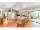 Kitchen with granite countertops, a large island, and a sliding glass door to the lanai at 8940 Sw 8Th St, Ocala, FL 34481