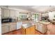 Bright kitchen with granite counters, a breakfast bar, and a view into the living room at 8940 Sw 8Th St, Ocala, FL 34481