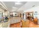 Open concept kitchen with granite counters and seamless connection to dining and living spaces at 8940 Sw 8Th St, Ocala, FL 34481