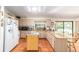 Open kitchen with island and bar seating, overlooking the lanai and pool at 8940 Sw 8Th St, Ocala, FL 34481