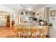 Bright kitchen featuring a granite island and breakfast bar with outdoor access at 8940 Sw 8Th St, Ocala, FL 34481