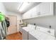 Laundry room with a tile floor, a sink, cabinets and a washer and dryer at 8940 Sw 8Th St, Ocala, FL 34481