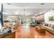 Open-concept living area featuring tile flooring and a brick fireplace at 8940 Sw 8Th St, Ocala, FL 34481