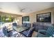 Covered patio area with glass table and seating, plus a built in sink and counter, perfect for entertaining at 8940 Sw 8Th St, Ocala, FL 34481
