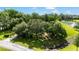 Wide angle landscape view of the beautiful lot with mature trees surrounding the homesite and a pond nearby at 8940 Sw 8Th St, Ocala, FL 34481