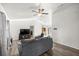Open-concept living room with a ceiling fan and wood-look floors at 9 Juniper Pass Trl, Ocala, FL 34480