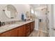 Modern bathroom with double vanity, granite countertop, and a glass-enclosed walk-in shower at 9309 Sw 106Th Ave, Ocala, FL 34481