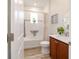Well-lit bathroom featuring a tub, shower combo, a white vanity with wood cabinets, and stylish fixtures at 9309 Sw 106Th Ave, Ocala, FL 34481