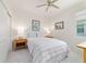 Light-filled bedroom with neutral décor, a ceiling fan, and two bedside tables with lamps at 9309 Sw 106Th Ave, Ocala, FL 34481