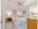 Light-filled bedroom with neutral décor, a ceiling fan, and two bedside tables with lamps at 9309 Sw 106Th Ave, Ocala, FL 34481