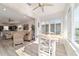Open-concept breakfast nook with bright windows, flowing into a cozy living space and kitchen at 9309 Sw 106Th Ave, Ocala, FL 34481