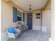 Cozy front porch with chairs and a table, offering a welcoming entrance to the home at 9309 Sw 106Th Ave, Ocala, FL 34481