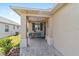 Inviting front porch featuring stylish patio furniture and a hanging lantern, creating a cozy outdoor space at 9309 Sw 106Th Ave, Ocala, FL 34481