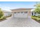 Spacious two-car garage with a paved driveway and well-maintained landscaping enhancing the property's appeal at 9309 Sw 106Th Ave, Ocala, FL 34481