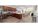 Open kitchen with stainless steel appliances, granite countertops, and a view of the dining and living areas at 9309 Sw 106Th Ave, Ocala, FL 34481