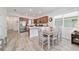 Bright kitchen with stainless steel appliances, wood cabinets, and an adjacent dining area with a wooden table at 9309 Sw 106Th Ave, Ocala, FL 34481