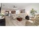 Open living area features a sectional sofa, wood floors, and an open kitchen at 9309 Sw 106Th Ave, Ocala, FL 34481