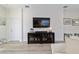 Open-concept living room featuring a TV, cabinet, and modern decor for a comfortable and stylish space at 9309 Sw 106Th Ave, Ocala, FL 34481