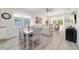 Open-concept living room and dining room with neutral decor and lots of natural light at 9309 Sw 106Th Ave, Ocala, FL 34481