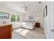 Bright main bedroom featuring a cozy bed, ceiling fan, and serene decor at 9309 Sw 106Th Ave, Ocala, FL 34481