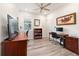 Bright office space with wood floors, a ceiling fan, and two work desks, perfect for working at home at 9309 Sw 106Th Ave, Ocala, FL 34481