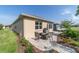 Backyard patio area with a fire pit, seating, landscaping, and a grill, perfect for entertaining at 9309 Sw 106Th Ave, Ocala, FL 34481