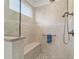 An elegant bathroom shower with pebble floor, a built-in bench, and sleek brushed nickel shower fixtures at 9309 Sw 106Th Ave, Ocala, FL 34481