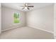 Bedroom with carpeted floor and a window view of the yard, bringing natural light indoors at 10121 Sw 130Th Ter, Dunnellon, FL 34432