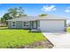 Charming single-story home with a well-manicured lawn and two-car garage at 10121 Sw 130Th Ter, Dunnellon, FL 34432