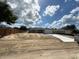 New home construction with a spacious lot and long driveway on a sunny day at 10121 Sw 130Th Ter, Dunnellon, FL 34432