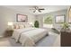 Comfortable bedroom featuring carpet, soft lighting, and a large window for natural light at 10121 Sw 130Th Ter, Dunnellon, FL 34432