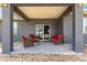 Inviting covered back porch featuring outdoor seating, ideal for entertaining and enjoying the backyard view at 10291 Se 67Th Ter, Belleview, FL 34420