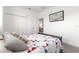 Comfortable bedroom featuring a dark wood bed frame, patterned quilt, and neutral decor at 10291 Se 67Th Ter, Belleview, FL 34420