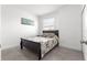 Cozy bedroom with a dark wood frame bed, a patterned quilt, and a bright window at 10291 Se 67Th Ter, Belleview, FL 34420