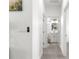 Bright hallway leading to a bathroom with white cabinets, vanity, and modern fixtures at 10291 Se 67Th Ter, Belleview, FL 34420