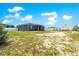 Rear exterior view of the home, showcasing a spacious backyard, shed, and outdoor living space at 10291 Se 67Th Ter, Belleview, FL 34420