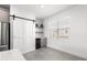 Kitchen area with a modern barn door, beverage fridge, stylish shelving and ample natural light at 10291 Se 67Th Ter, Belleview, FL 34420