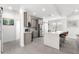 Open kitchen featuring gray cabinets, stainless steel appliances, a barn door and a large island at 10291 Se 67Th Ter, Belleview, FL 34420