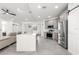 Spacious kitchen with gray cabinets, stainless steel appliances, island, and open layout at 10291 Se 67Th Ter, Belleview, FL 34420