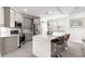 Stylish kitchen featuring gray cabinets, stainless steel appliances, and a large island with bar seating at 10291 Se 67Th Ter, Belleview, FL 34420